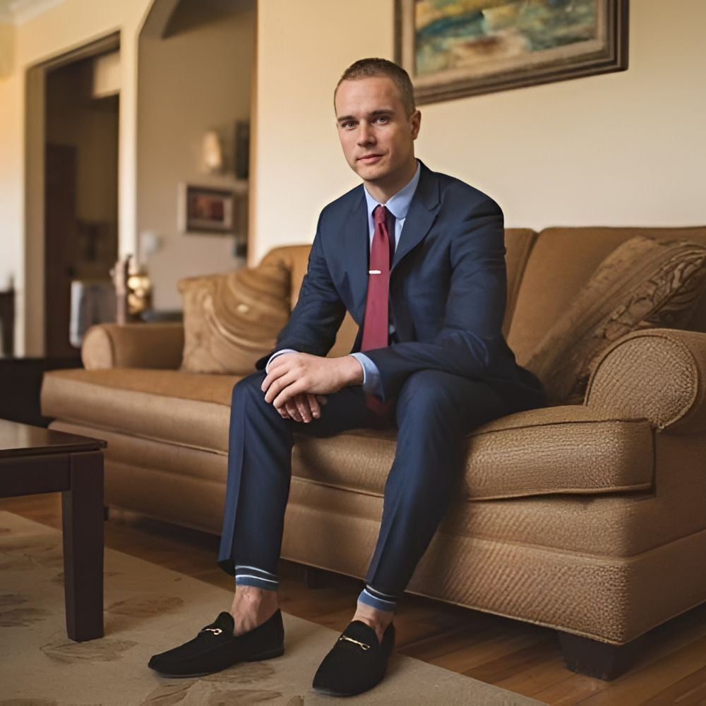 male model sitting on sofa in loafers